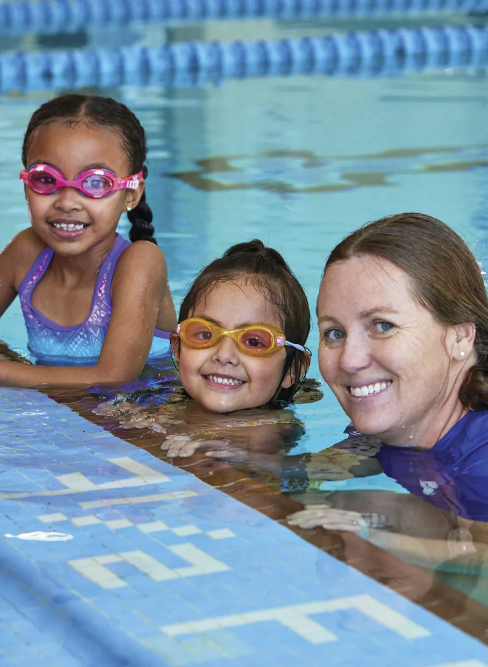 swim instructor with 2 swimmers