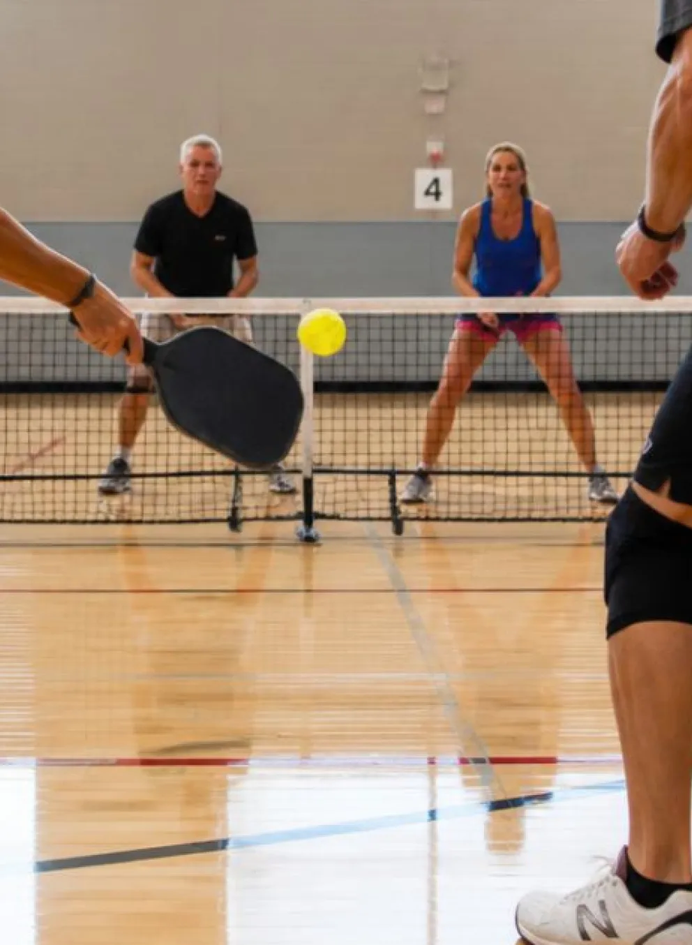 4 players playing pickleball