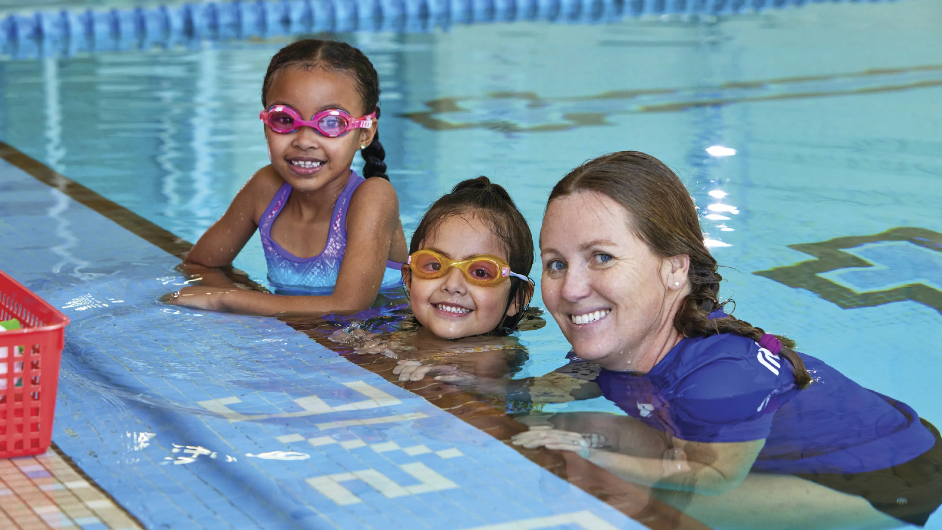 swim instructor with 2 swimmers