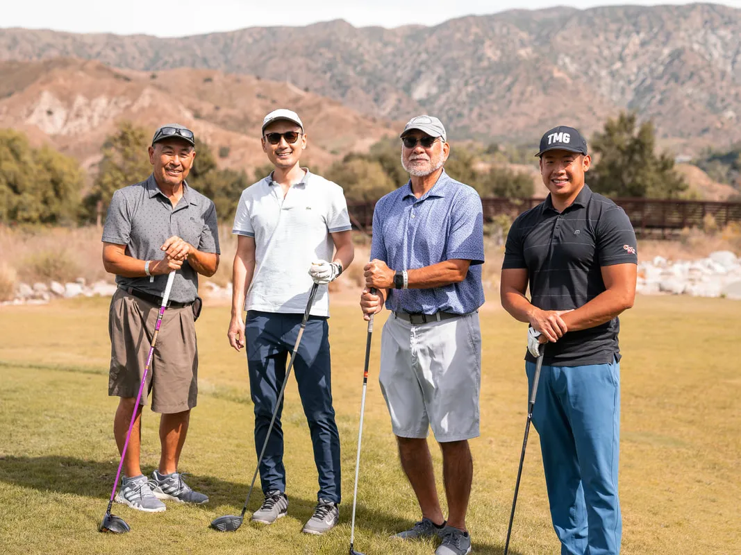 group of male golfers standing on the green.